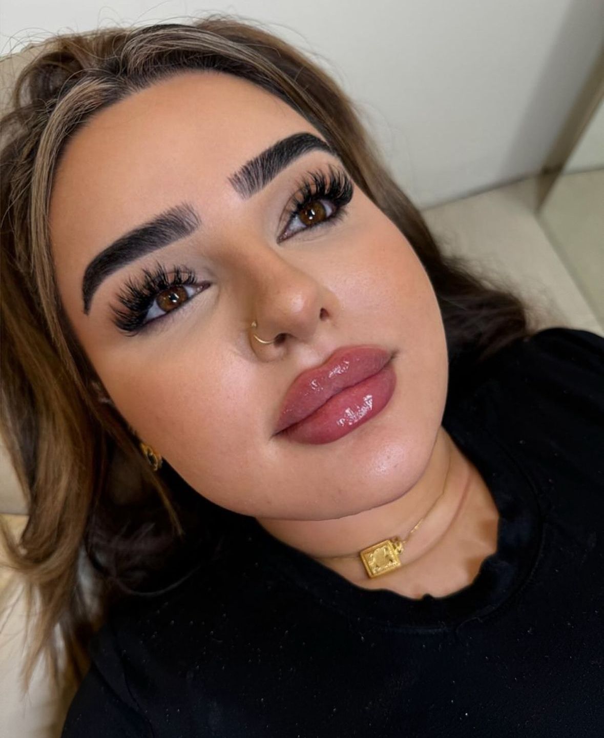 A Close Up of a Woman 's Face With a Necklace Around Her Neck — Doll Empire Clinic in Mermaid Beach, QLD