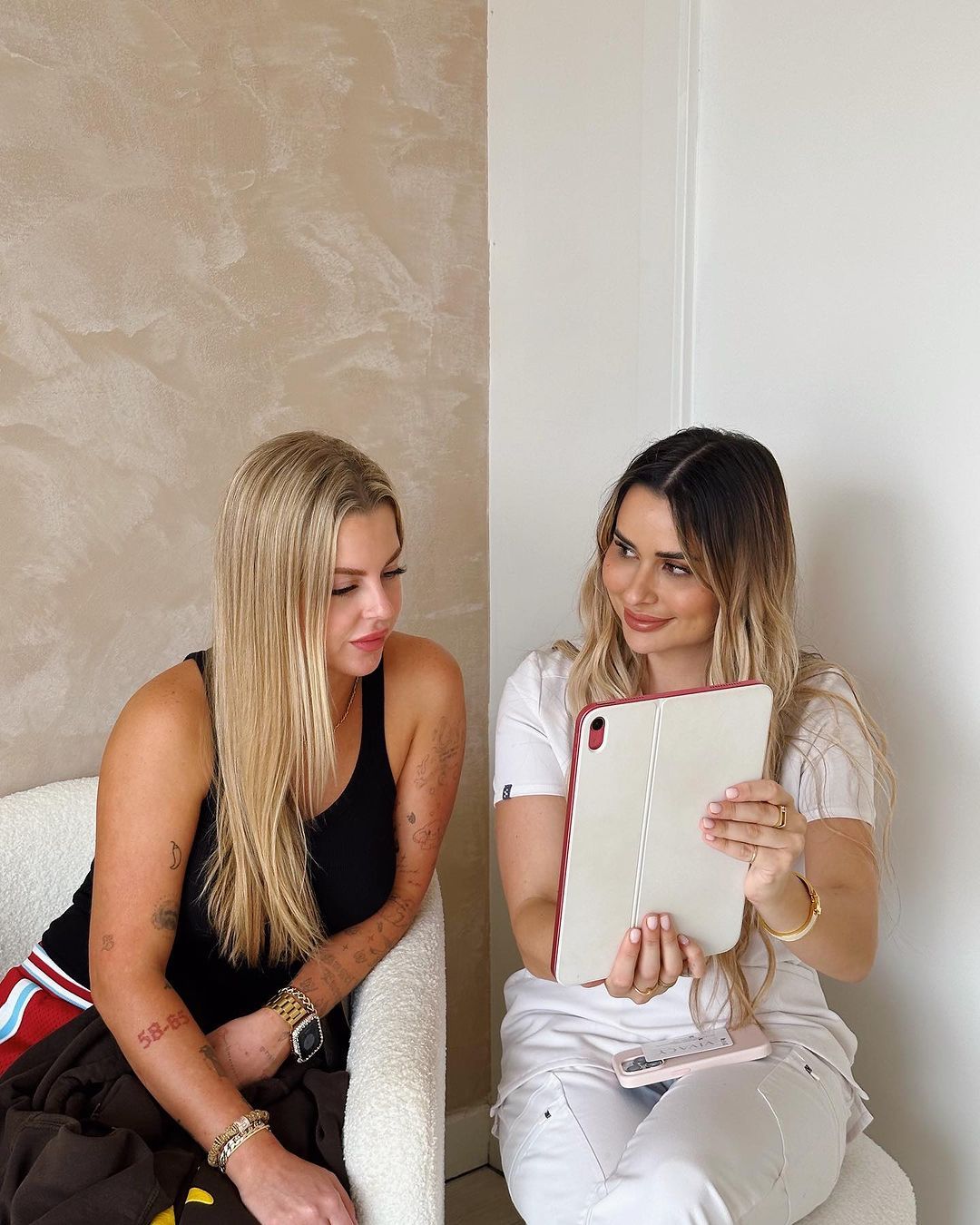 Certified Cosmetic Holding Ipad To Show Client— Doll Empire Clinic in Mermaid Beach, QLD