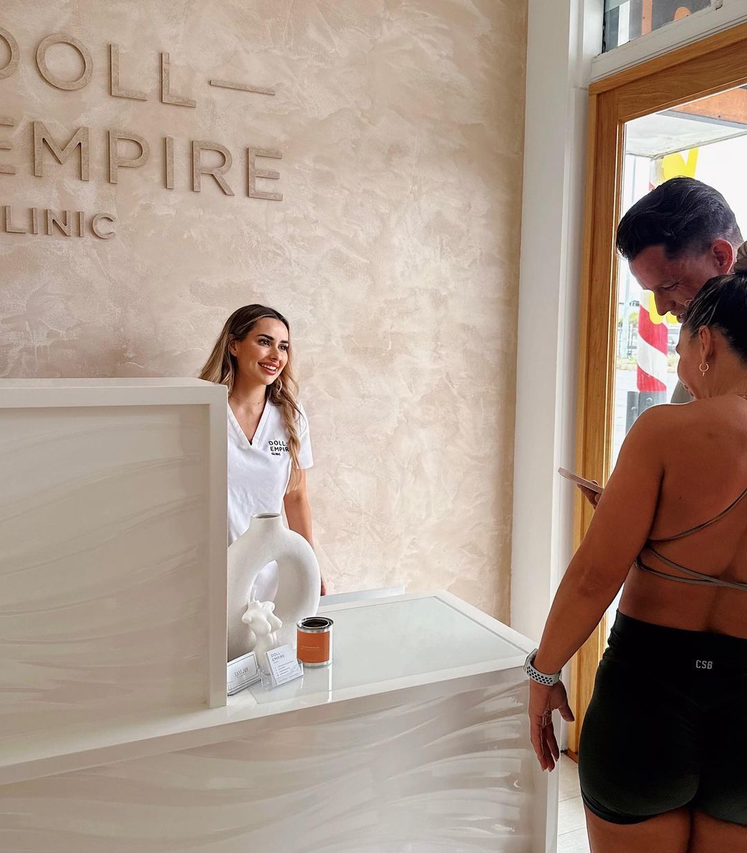 Women Smiling At Customers At Reception — Doll Empire Clinic in Mermaid Beach, QLD