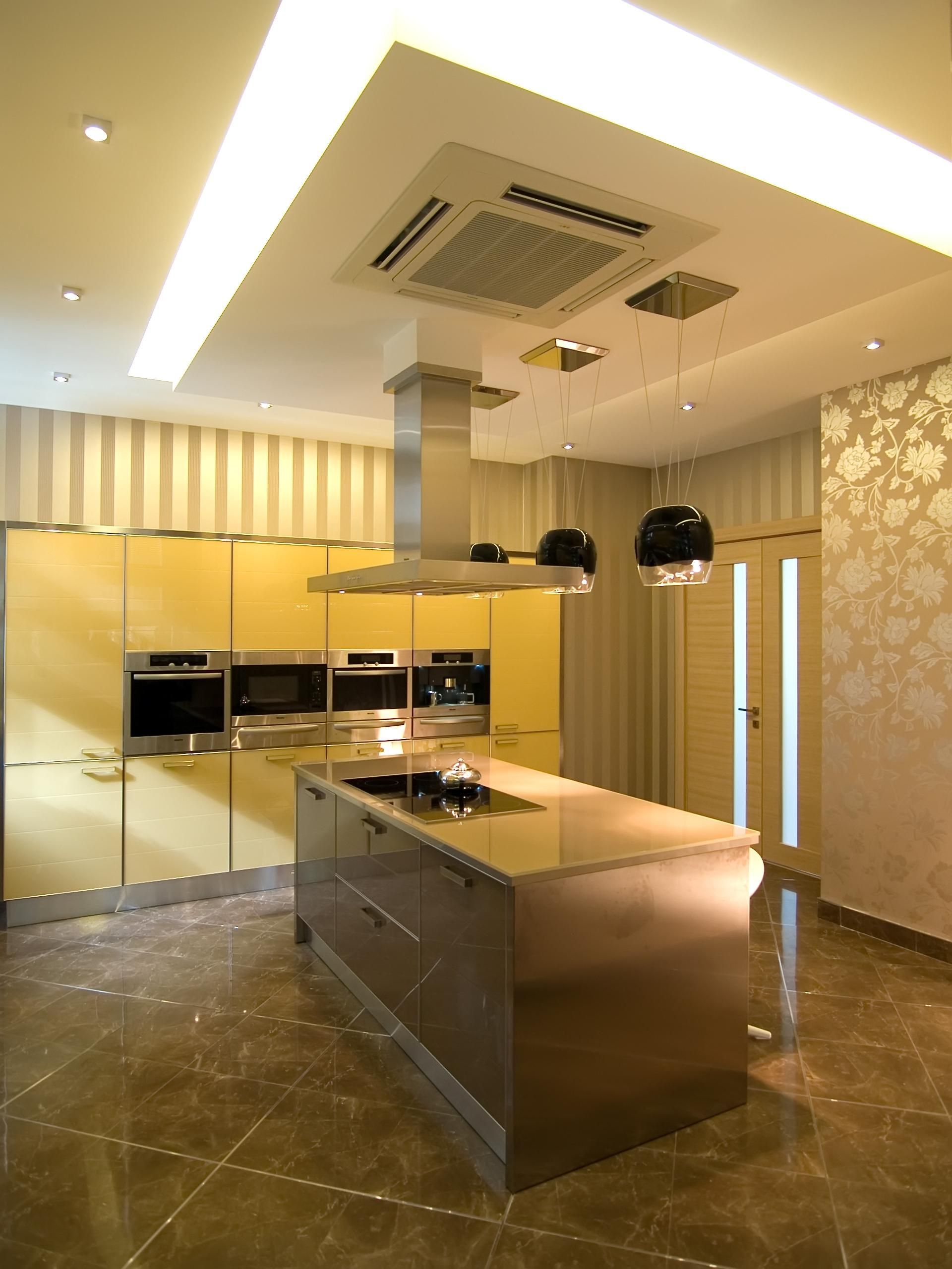 A kitchen with stainless steel appliances and a large island.