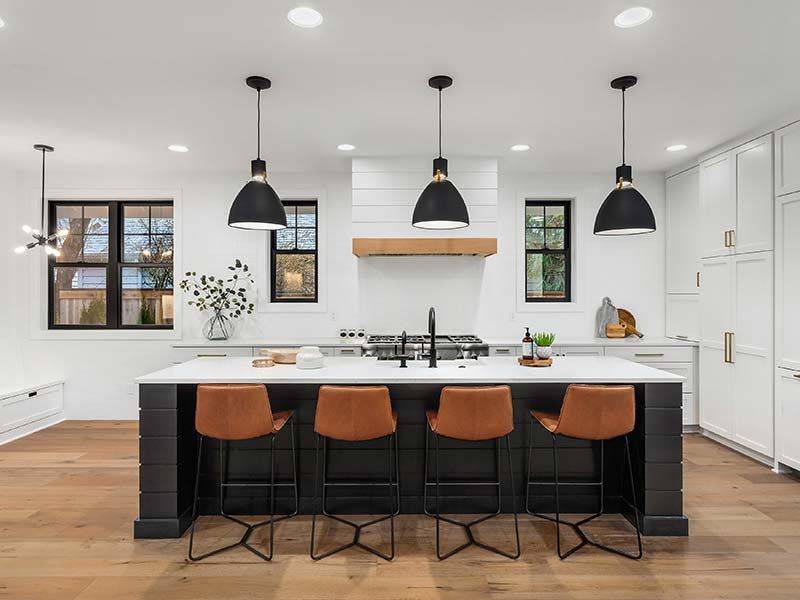 It is a kitchen with a large island and stools.
