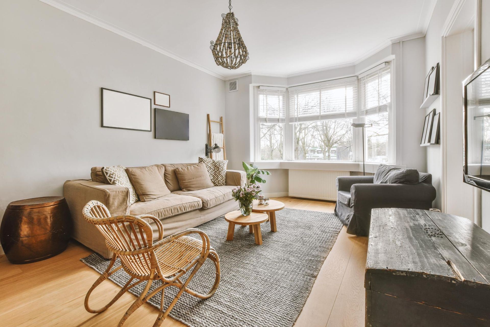 A living room with a couch, chairs, and a television.