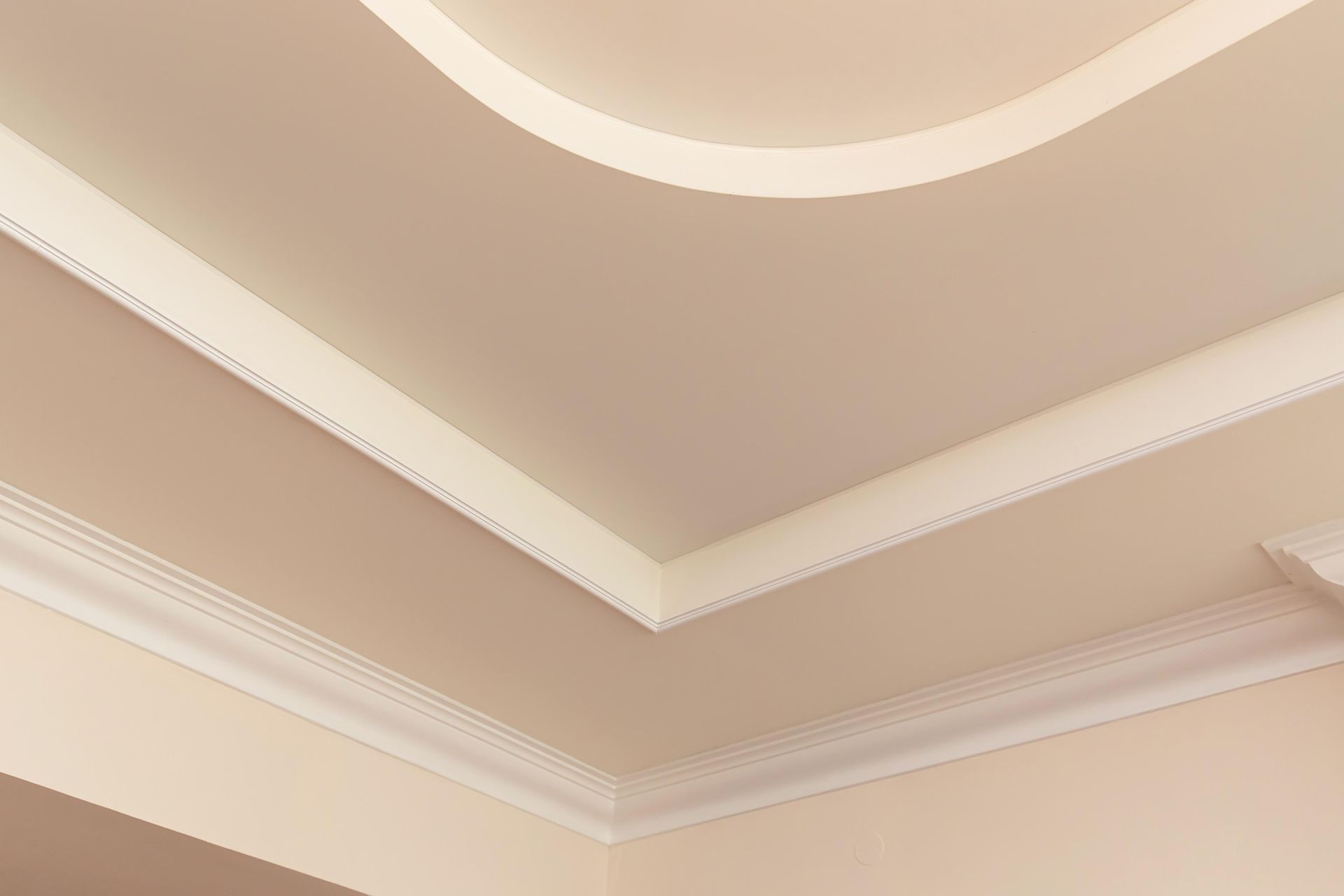 A close up of a ceiling with a white molding.