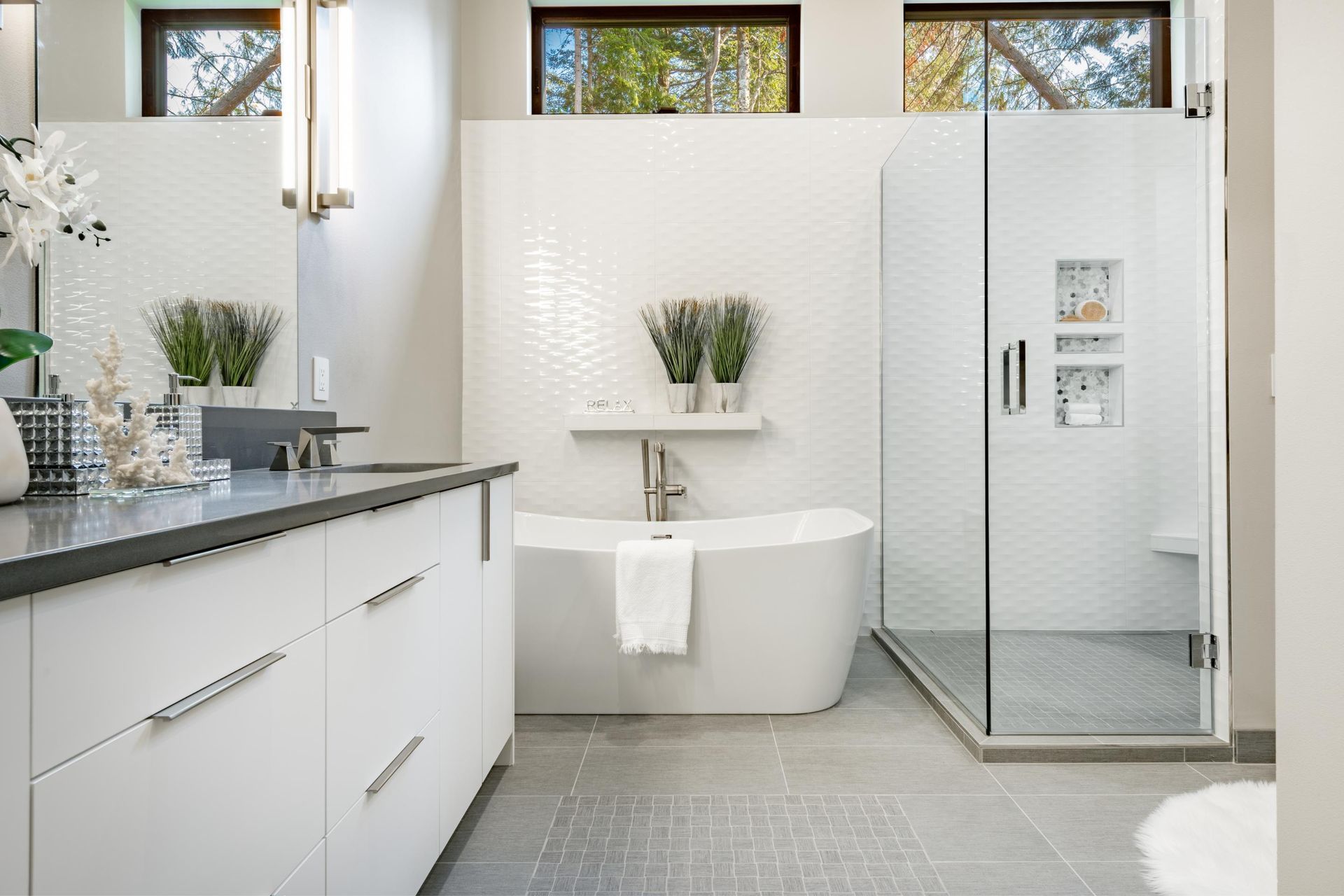 A bathroom with a bathtub and a walk in shower.