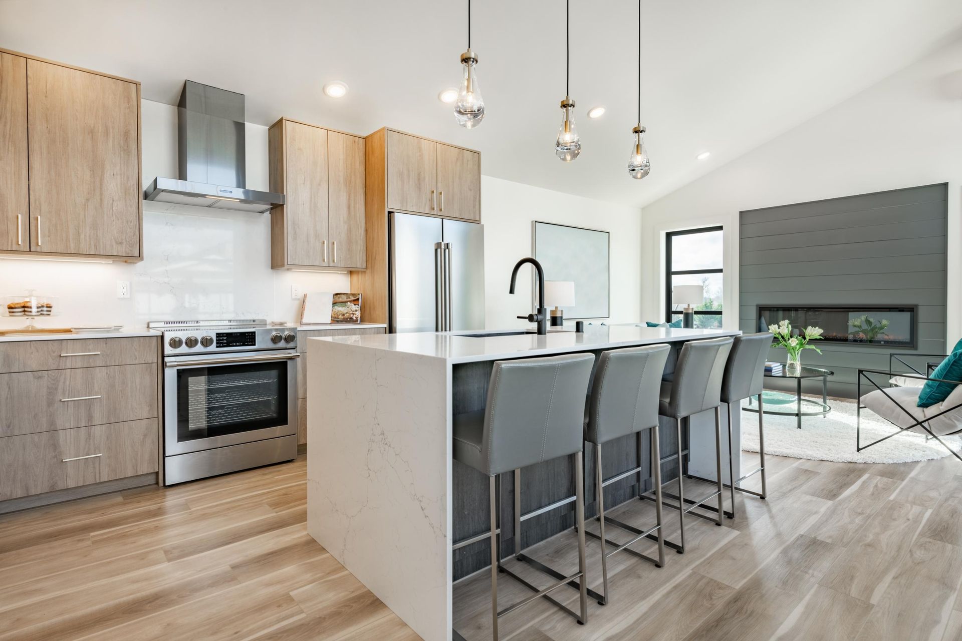 A kitchen with a large island and stools.