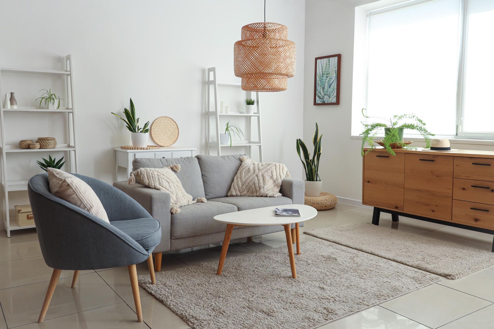 A living room with a couch, chairs, and a table.