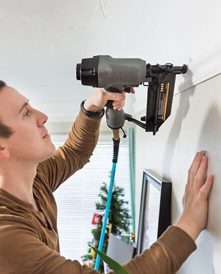 A Man Installing Trim Moldings.