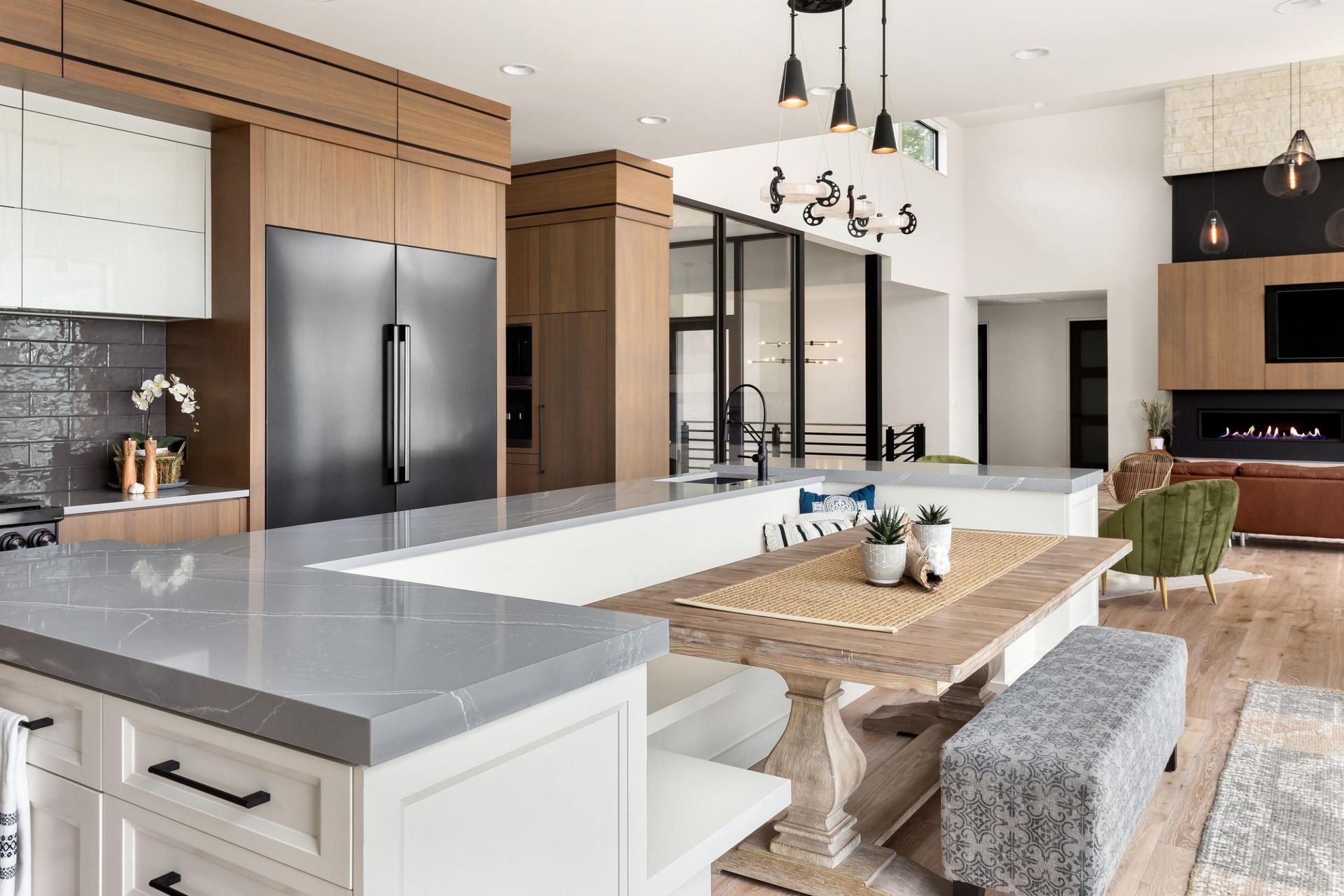 A kitchen with a large island and a dining table.