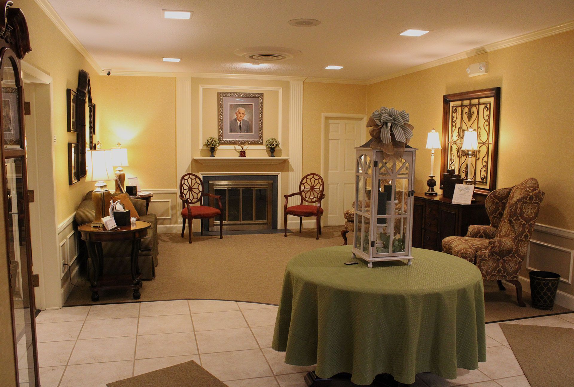 A living room with a table and chairs and a fireplace