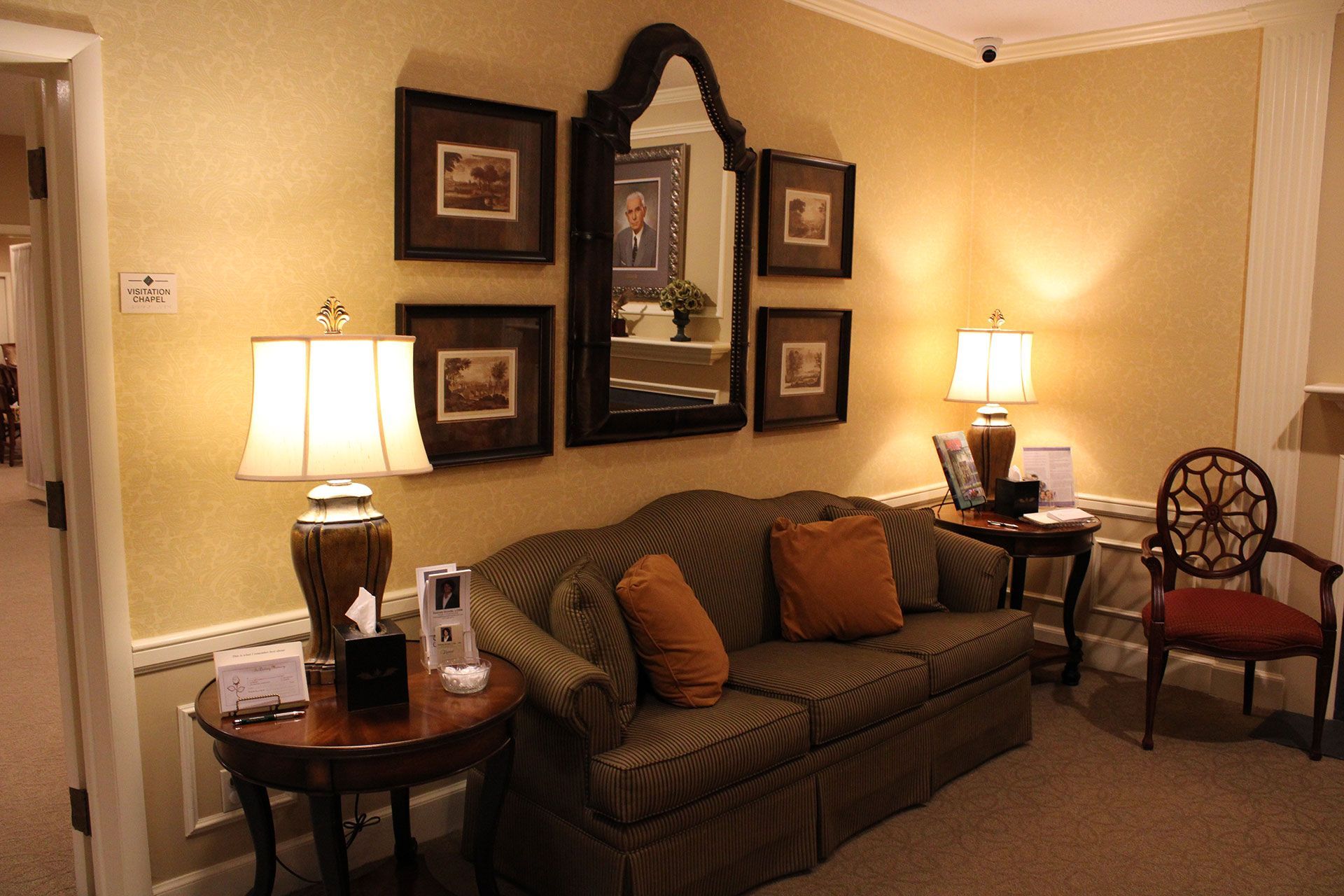 A living room with a couch lamps and chairs