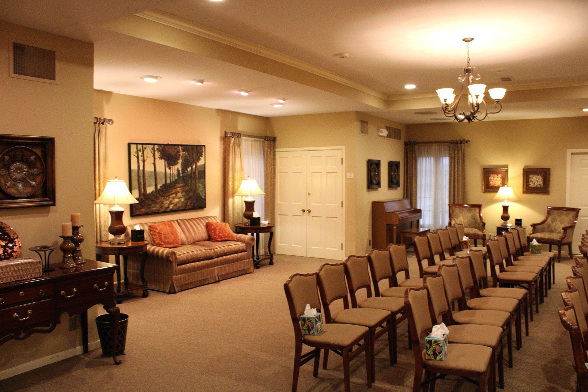 A large room with a lot of chairs and a couch.