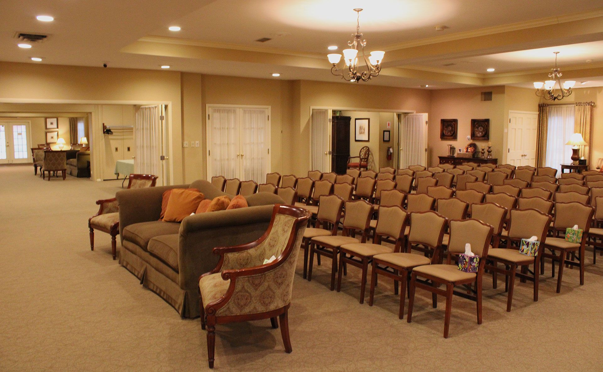 A large room with rows of chairs and a couch