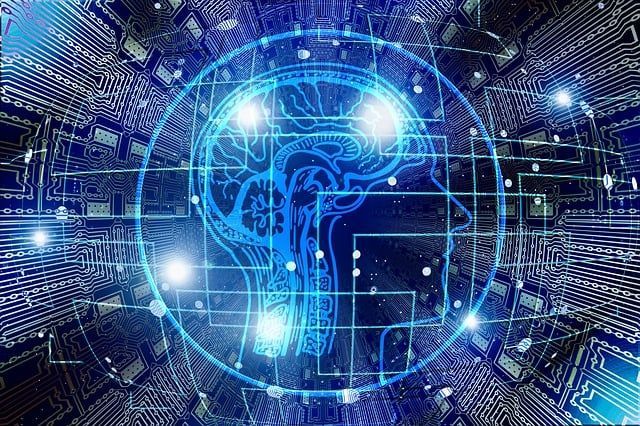 Blue digital human brain outline over circuit board.