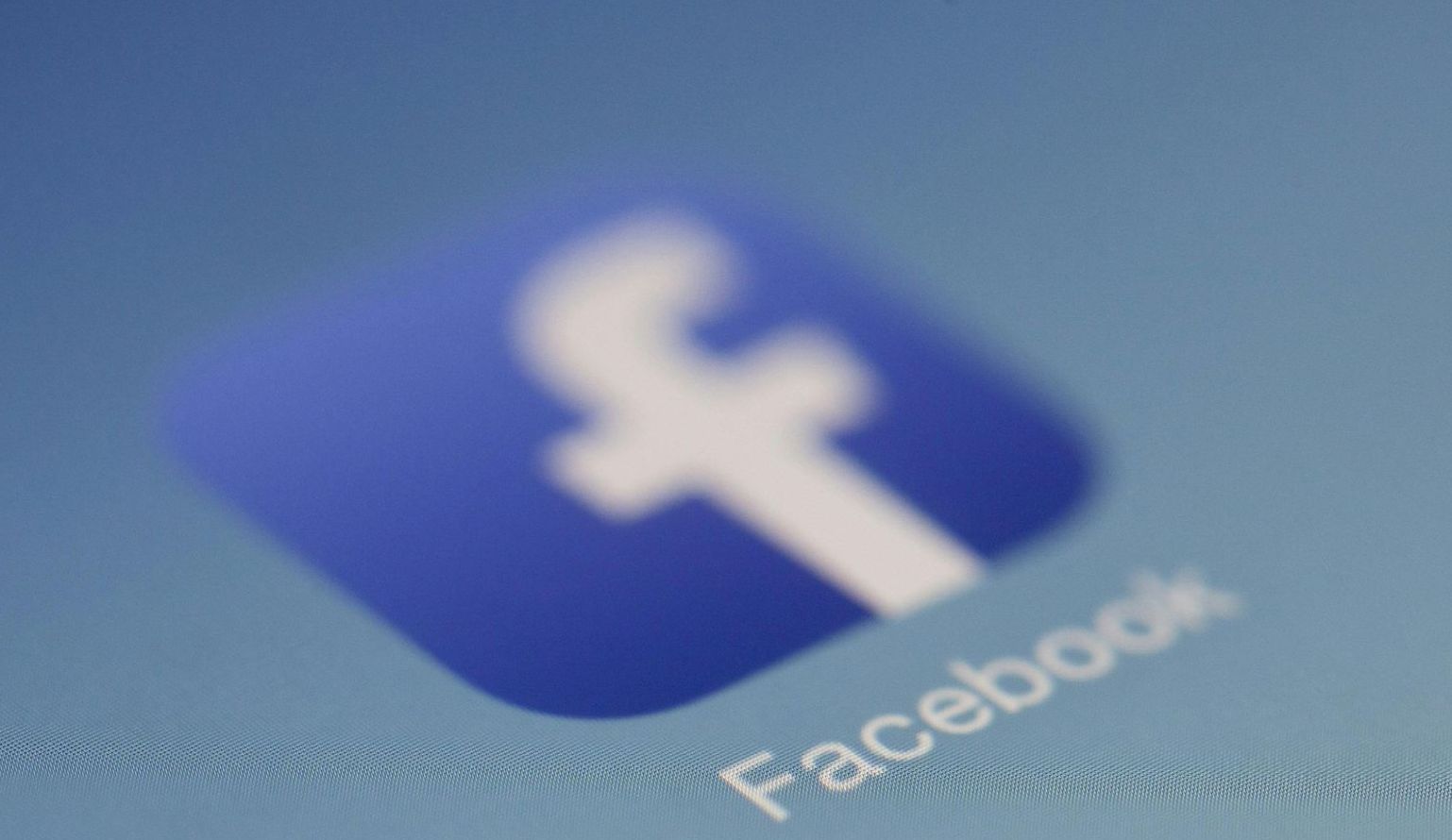 A close up of a facebook logo on a blue background