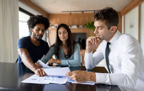 A financial advisor talking to a couple about their business plan.