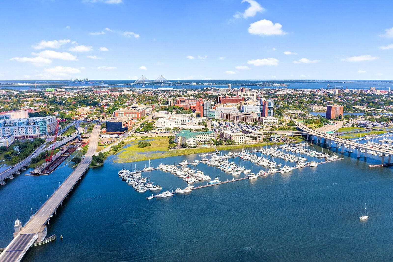 An aerial view of a city surrounded by water and boats.