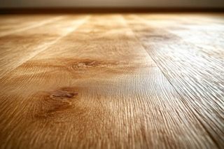 A close up of a wooden floor with a herringbone pattern.