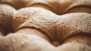 A close up of a white marble texture with gold veins.