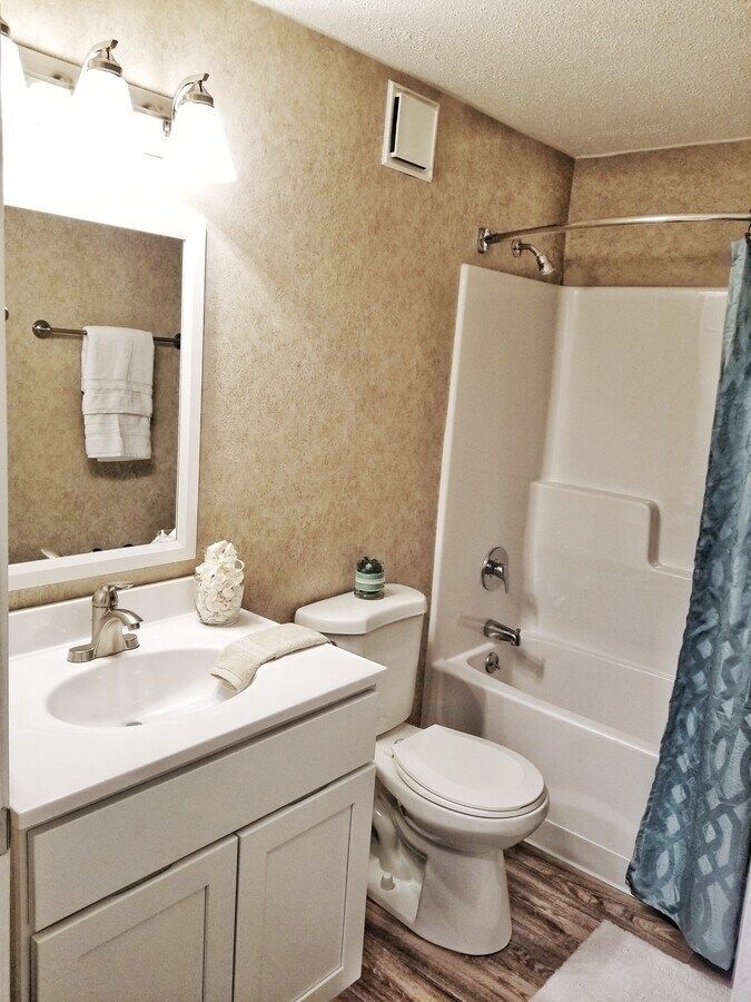 A bathroom with a toilet a sink and a bathtub