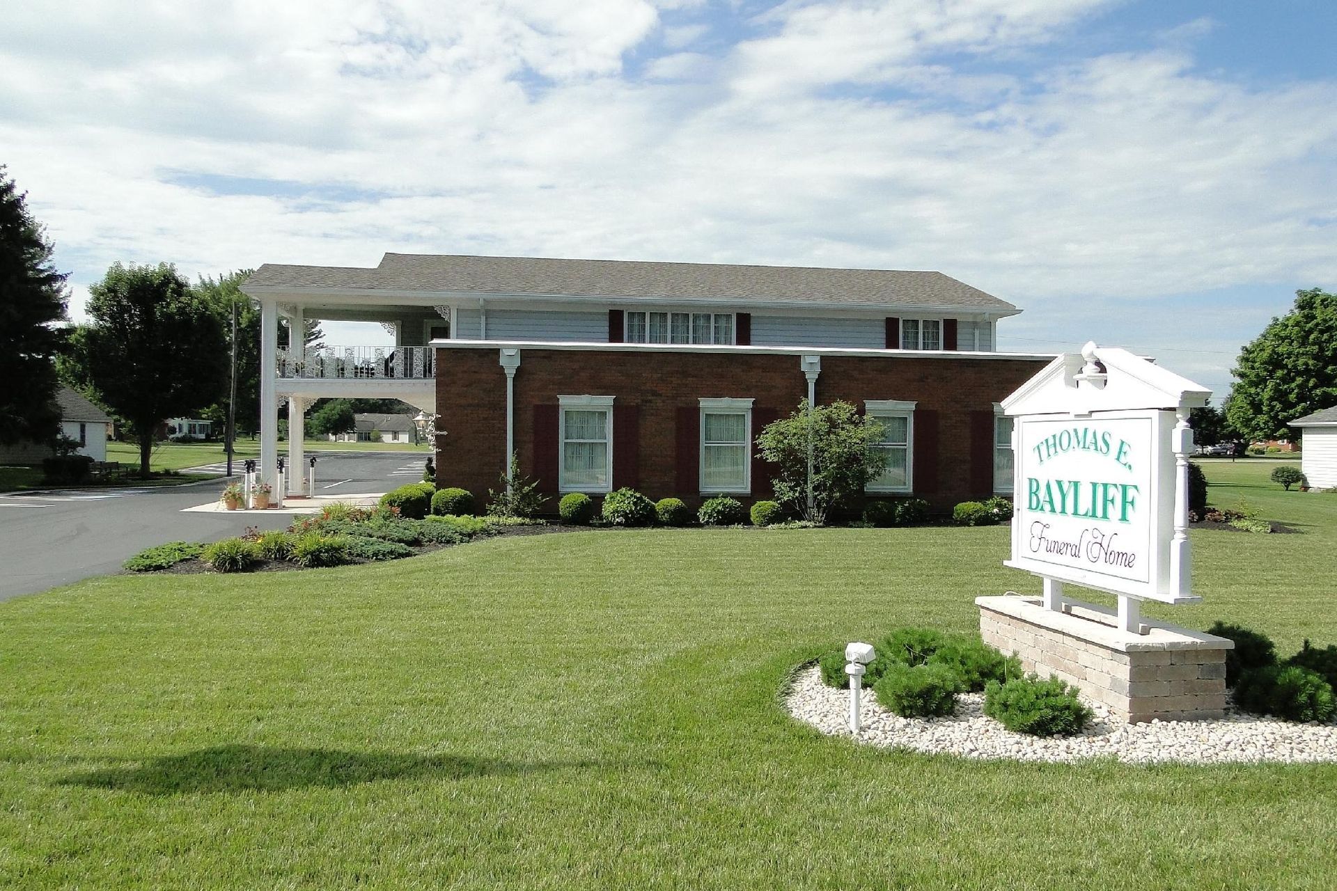 Exterior view of the Valleycliffe Senior Center, a two-story building with a brick facade and sign on a grassy lawn.