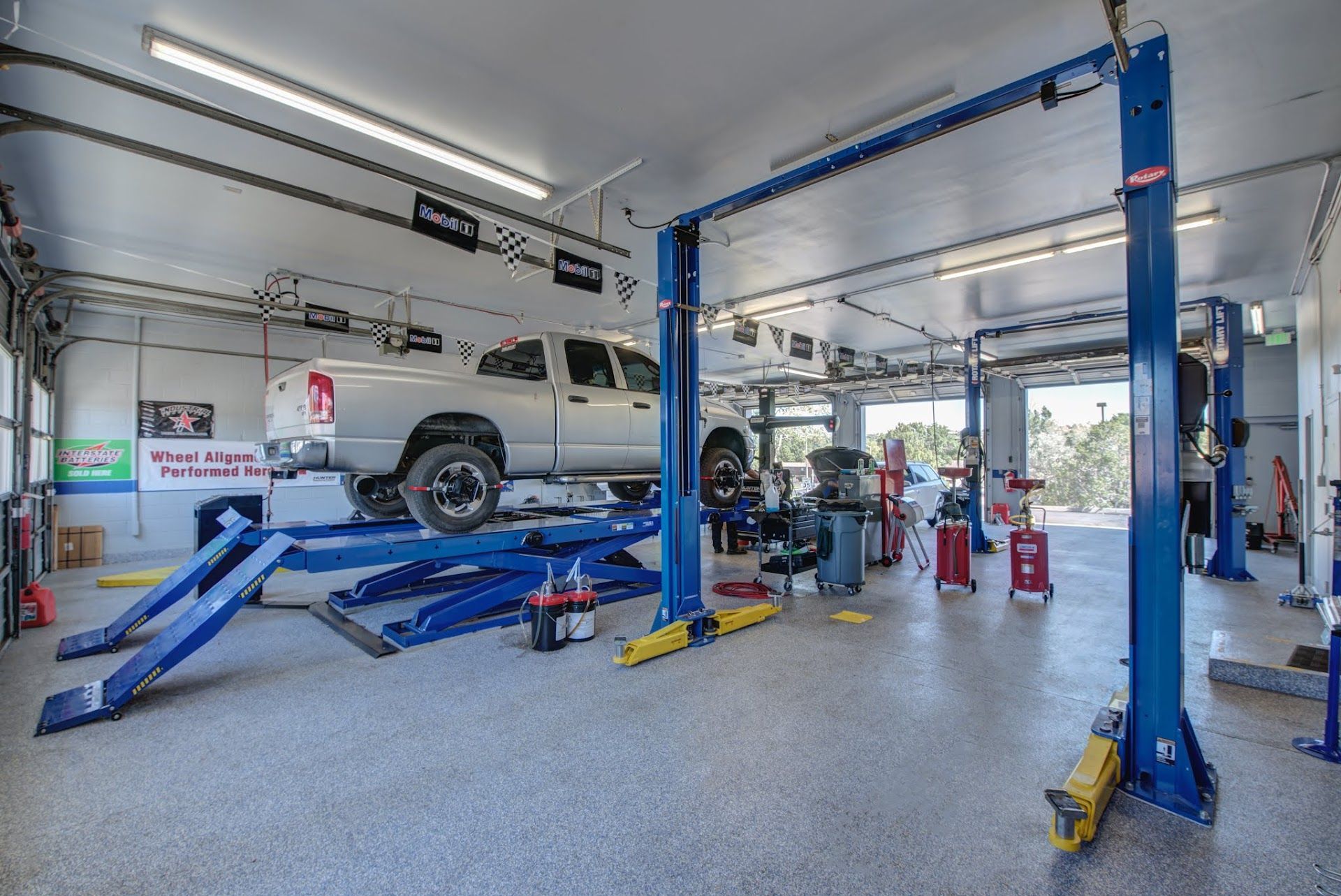 Vehicle on Hydraulic Lift Inside Auto Repair Bay | Anthony's Pro Auto