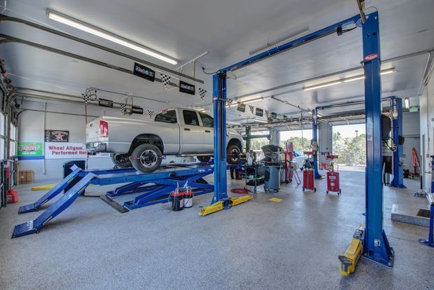 Vehicle on Hydraulic Lift Inside Auto Repair Bay | Anthony's Pro Auto