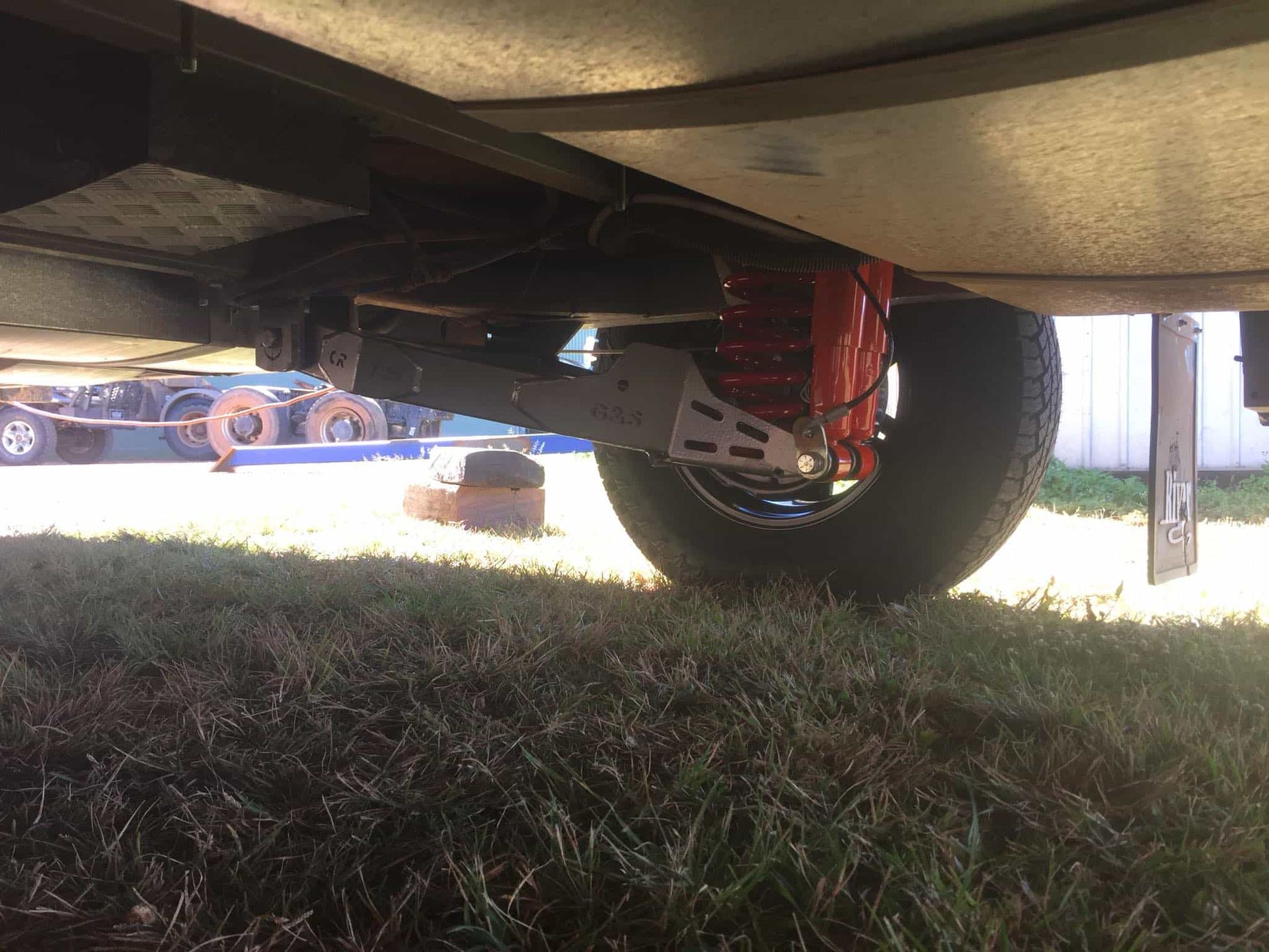 Undercarriage of Trailer With Red Shock Absorber — Boycey's Custom Engineering in Atherton, QLD
