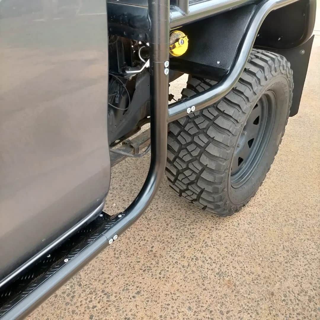 Gray Truck Side With Black Roll Cage, Off-road Tire — Boycey's Custom Engineering in Atherton, QLD