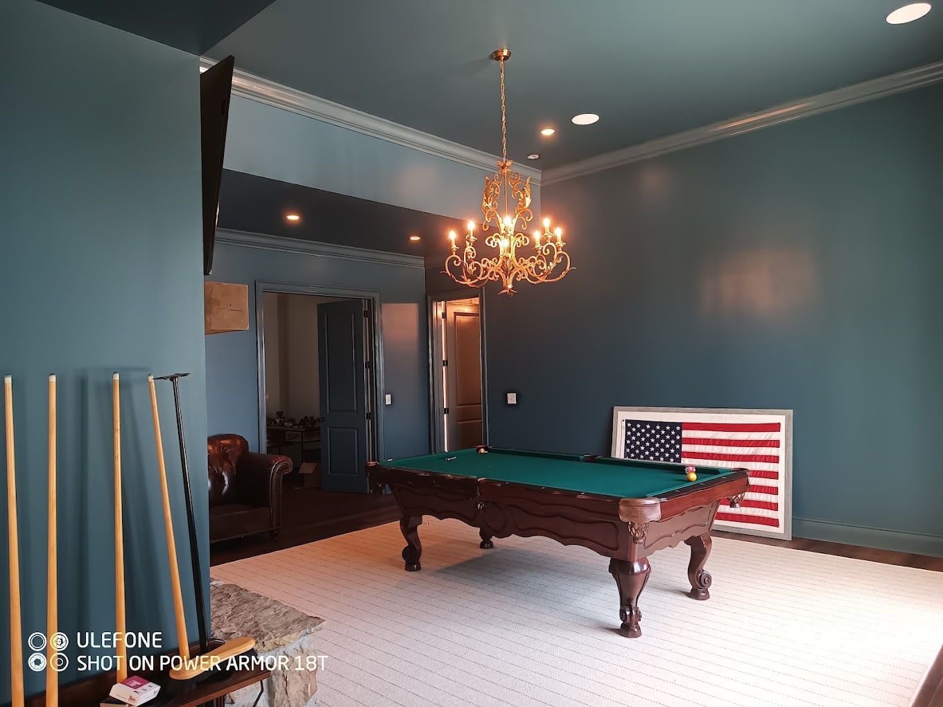 There is a pool table in the middle of the room.