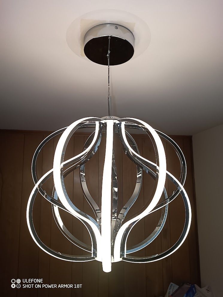 A chandelier is hanging from the ceiling in a room.