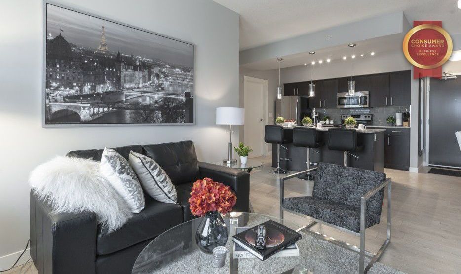 Living room with black love seat in a furnished condo in Edmonton