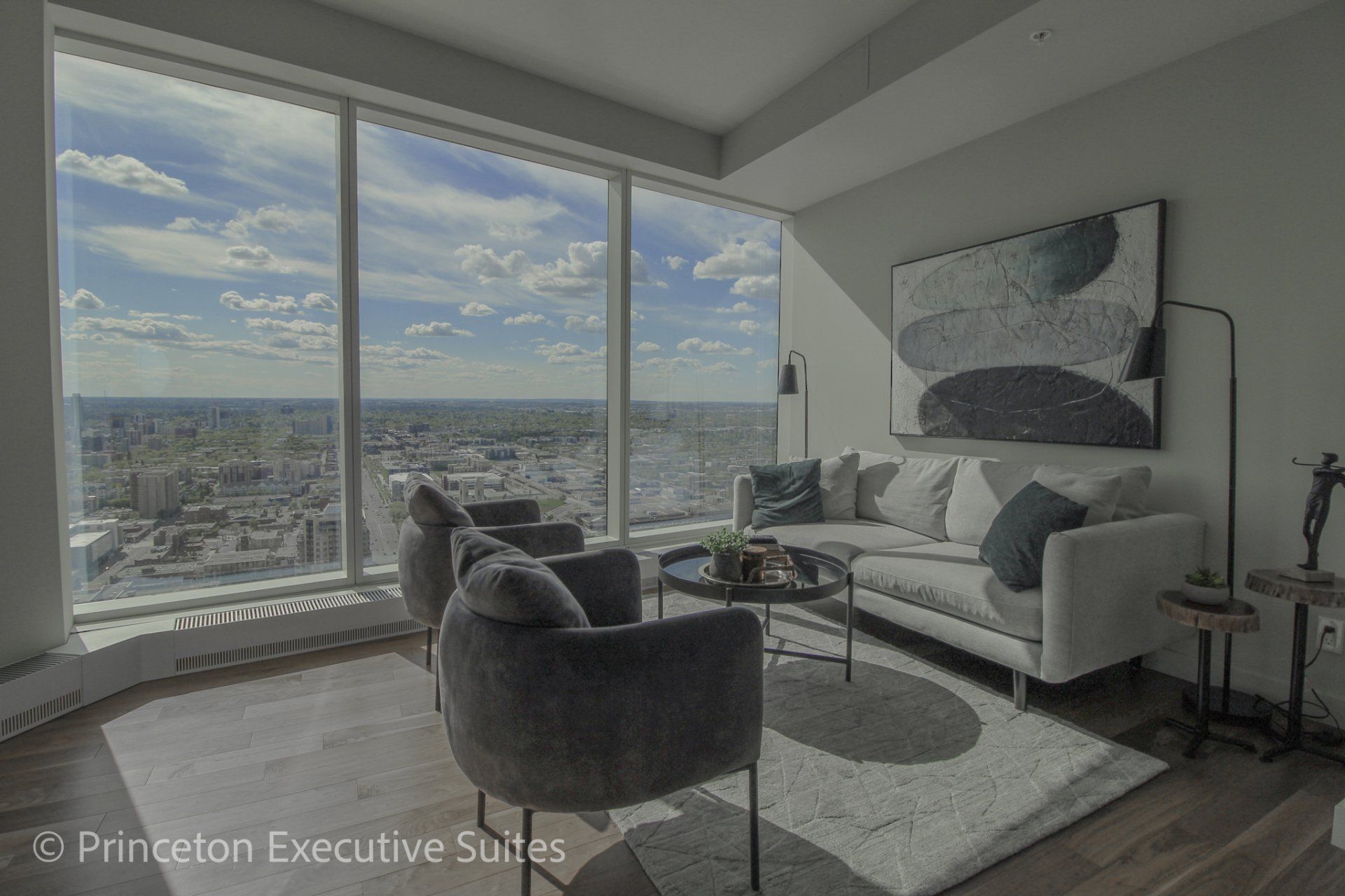 Spectacular view in this stunning furnished apartment in the legends tower downtown edmonton.  Grey furnishings , ceiling to floor windows