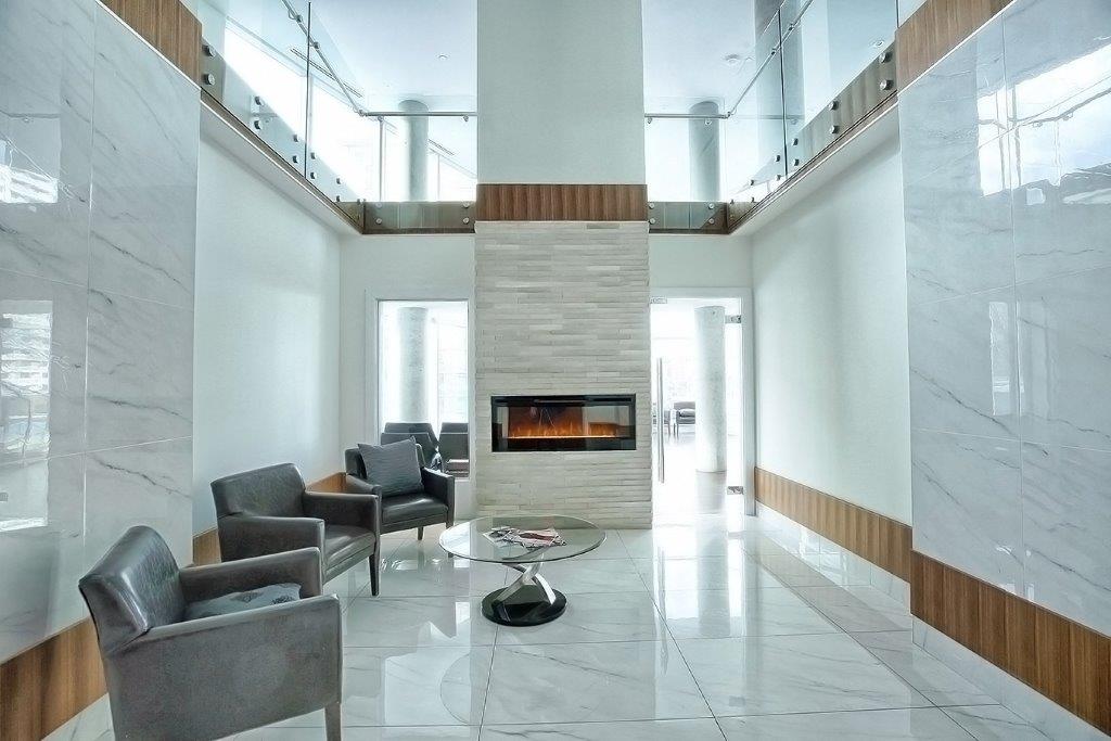 White marble living area, electric fireplace and modern seating