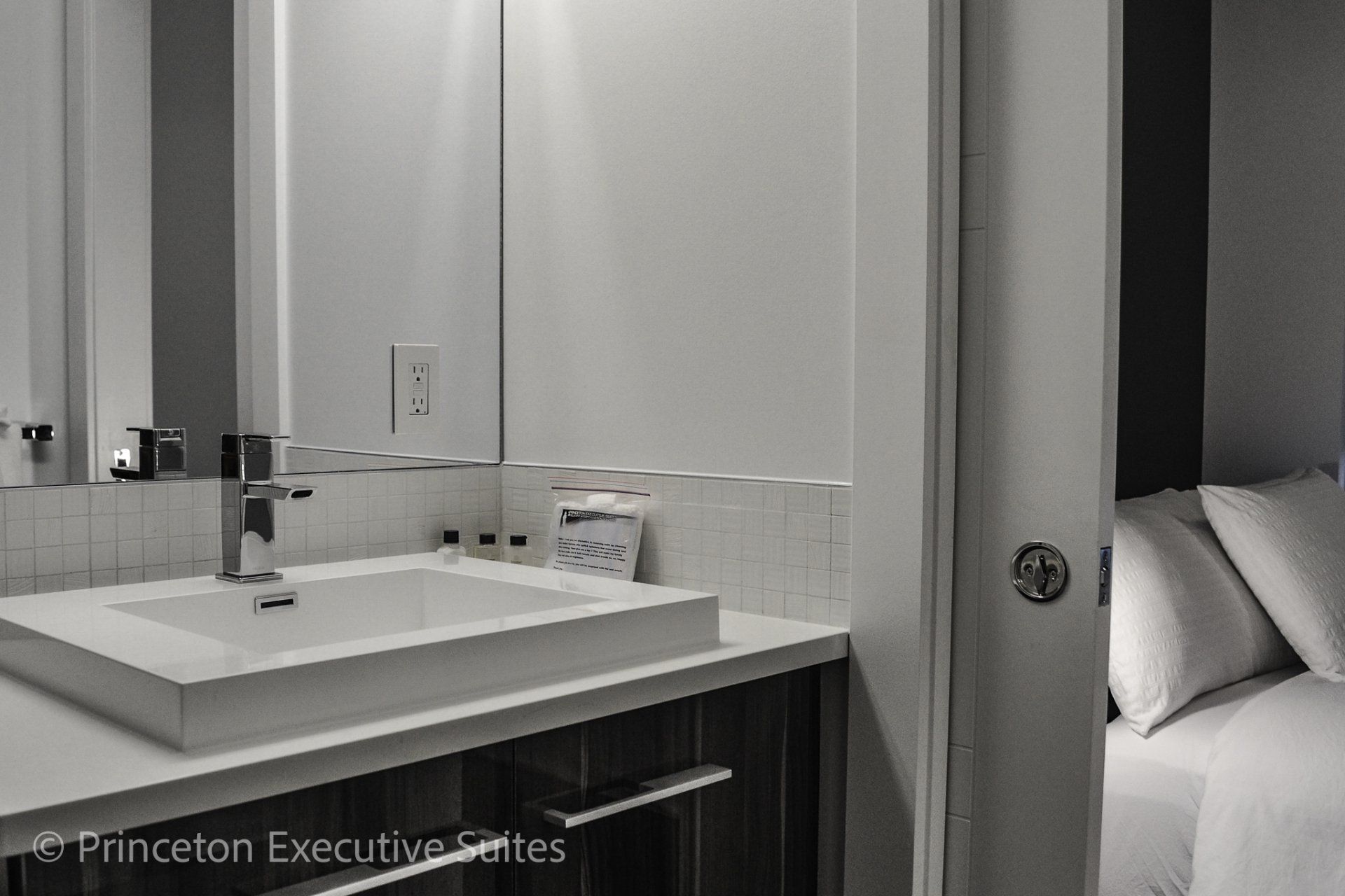 Black and grey vanity in this bathroom of a modern executive suite in Edmonton
