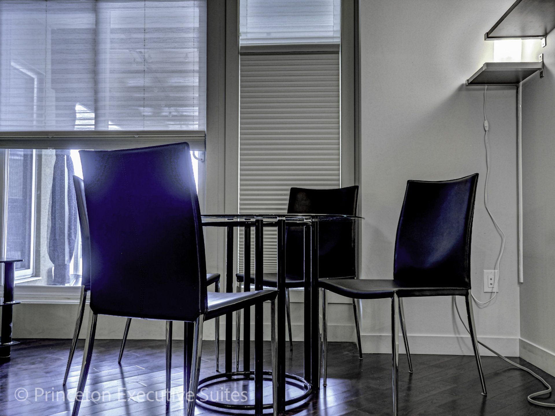 Black leather and glass dinette set in a Edmonton furnished suite