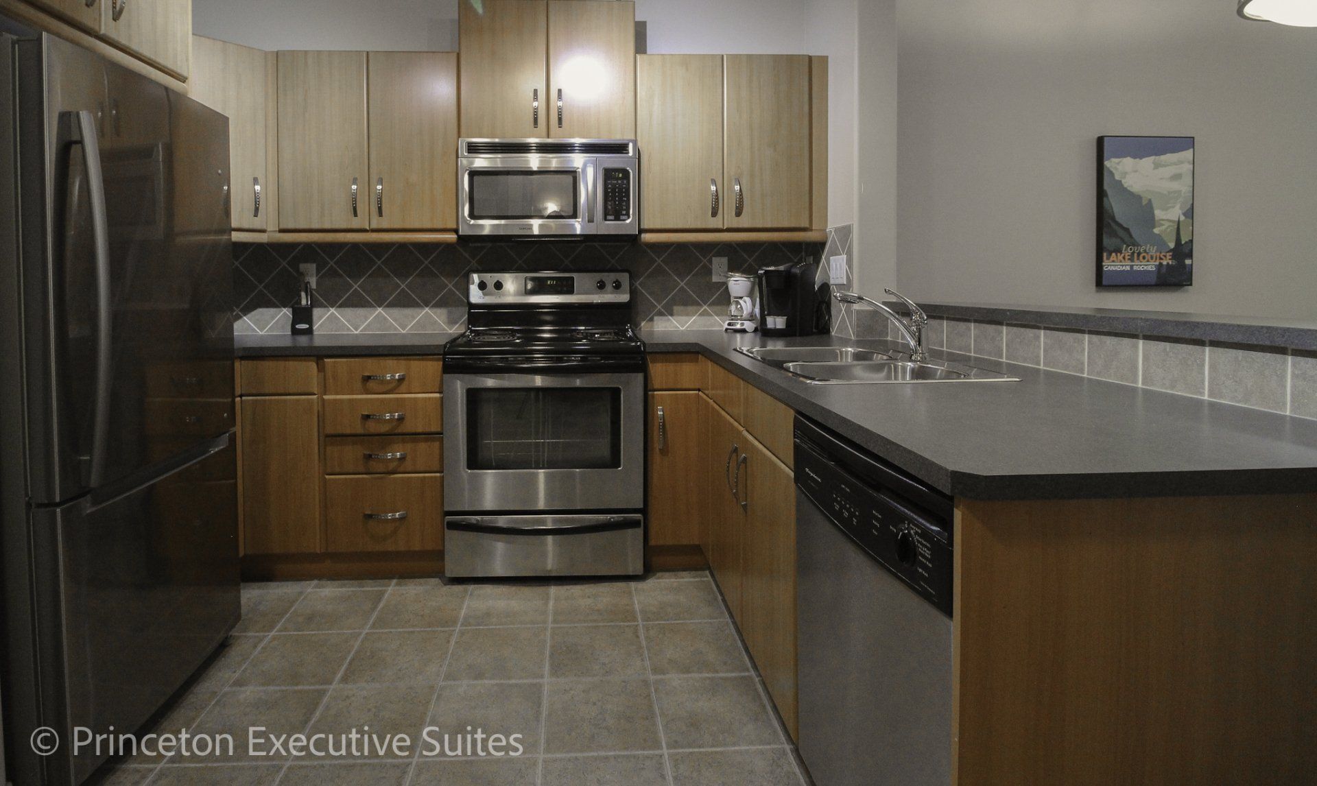 Maple cabinets and stainless steel appliances in Edmonton furnished apartment