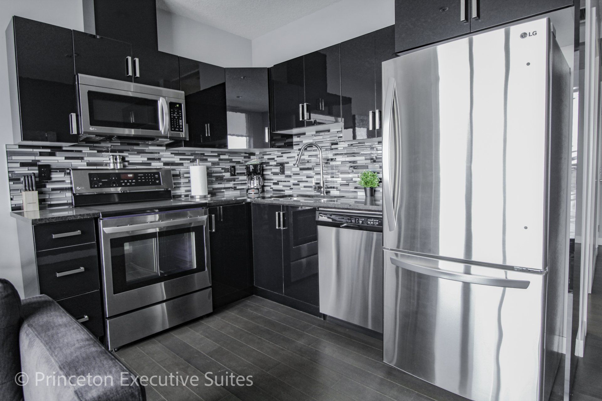 Stainless steel fridge stove and microwave in this furnished condo