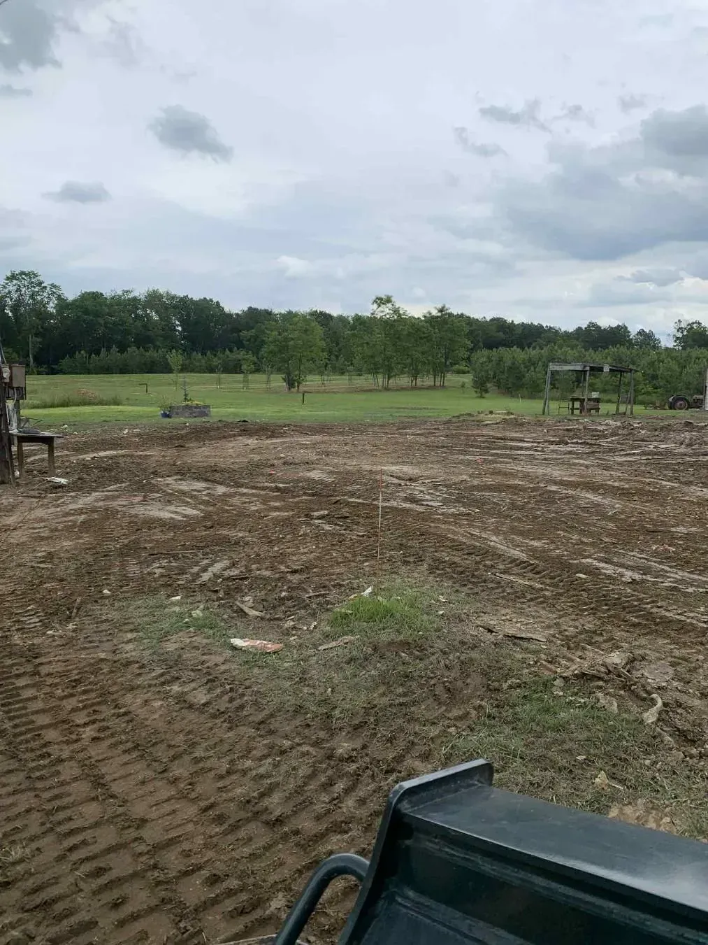 A bulldozer is moving dirt on top of a hill.