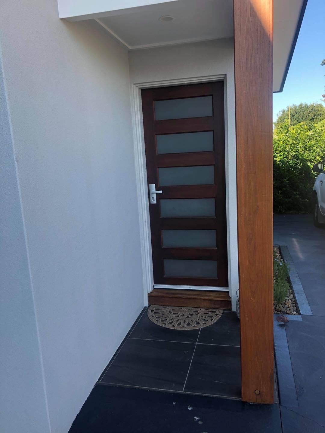 The Front Door Of A House With A Door Mat On The Ground — Central Coast Flyscreen Service In West Gosford, NSW