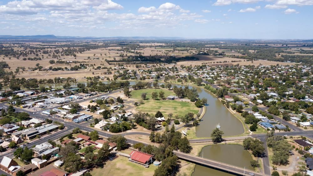 An Aerial View Of A Small Town With A Bridge Over A River — Central Coast Flyscreen Service In West Gosford, NSW