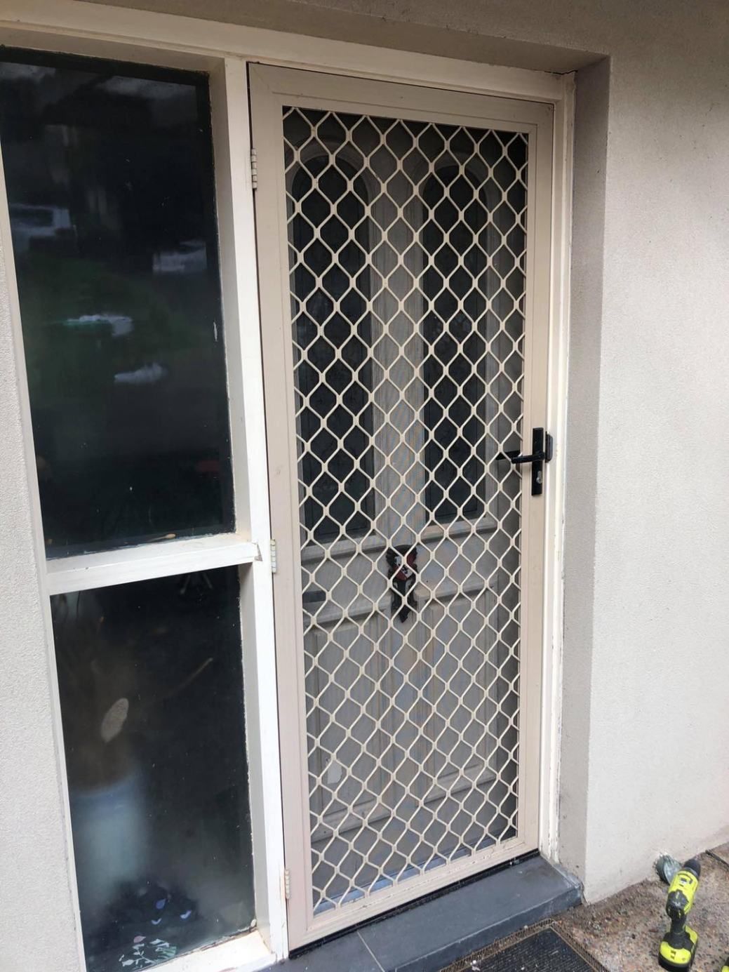 A White Door With A Diamond Pattern On It — Central Coast Flyscreen Service In West Gosford, NSW