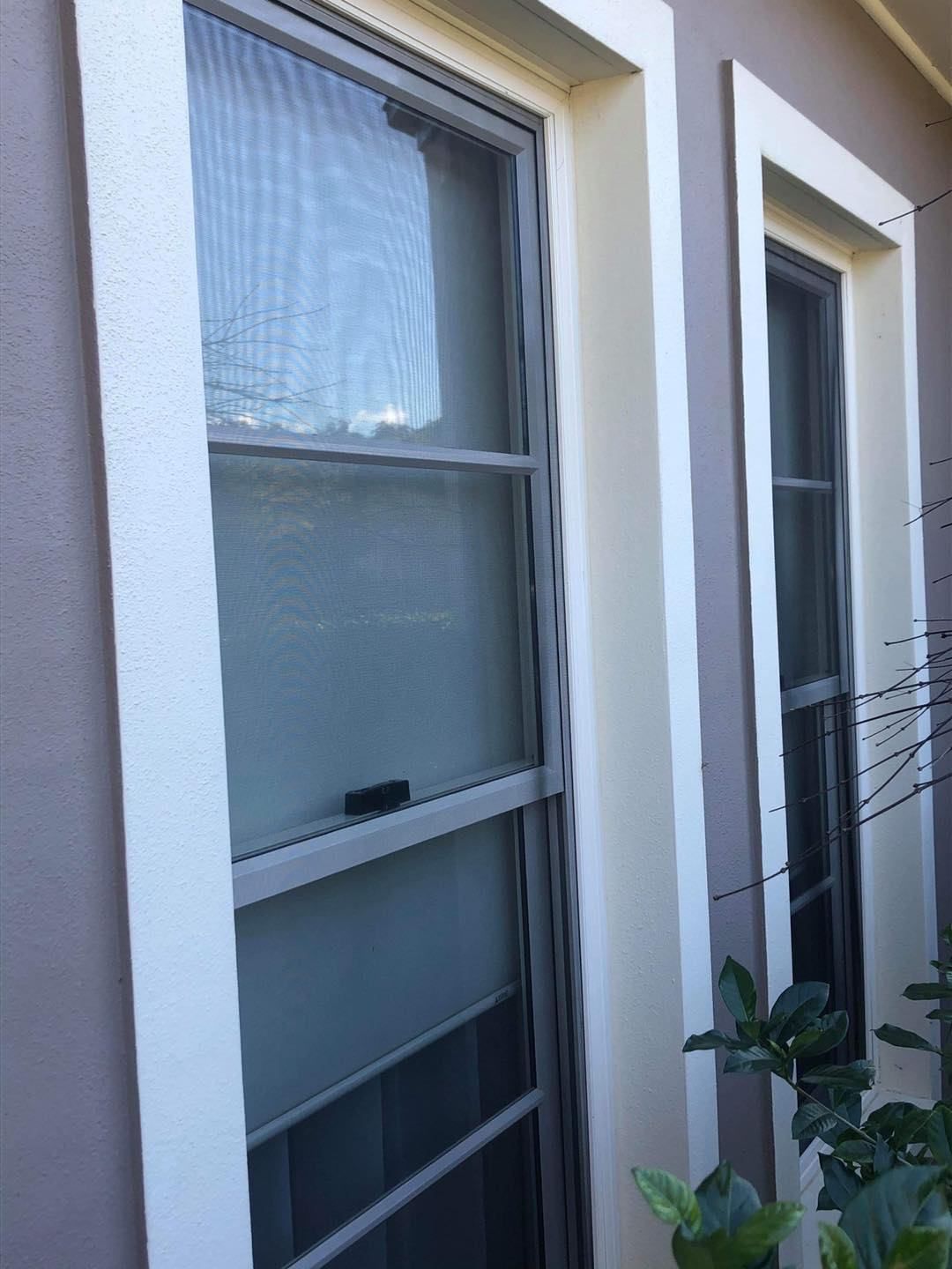 There Are Two Windows On The Side Of A Building — Central Coast Flyscreen Service In West Gosford, NSW
