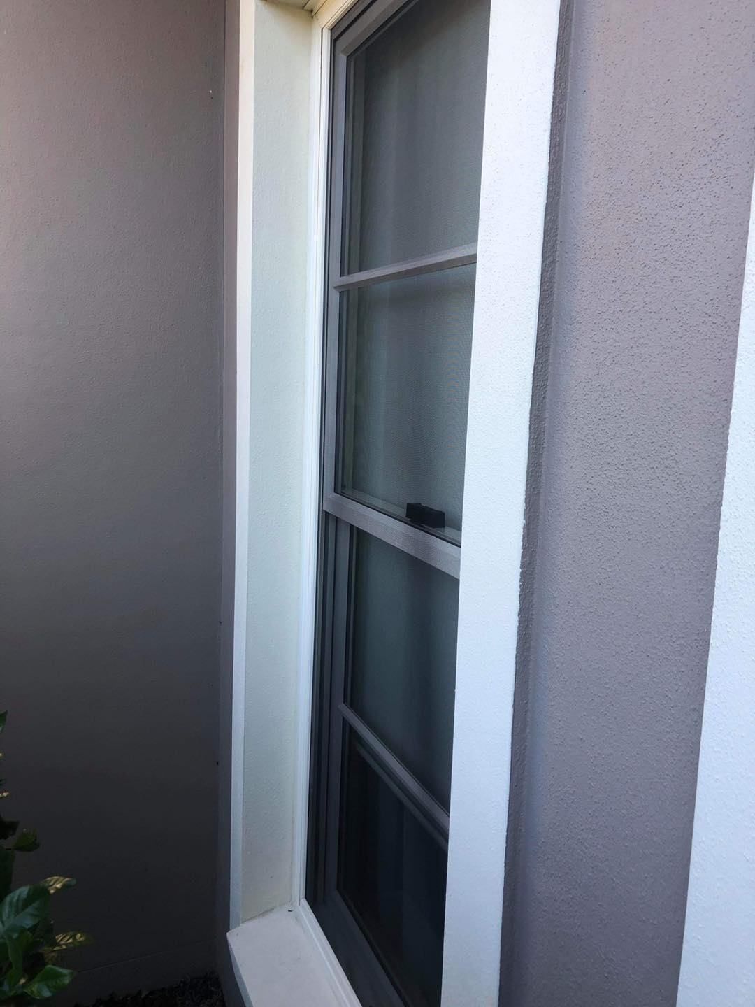 A Window With A Screen On It Is On The Side Of A Building — Central Coast Flyscreen Service In Woy Woy, NSW