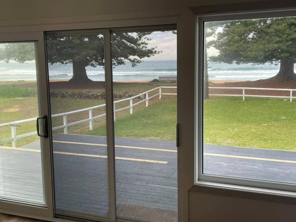 A Room With A Sliding Glass Door And A View Of The Ocean — Central Coast Flyscreen Service In Wyee, NSW