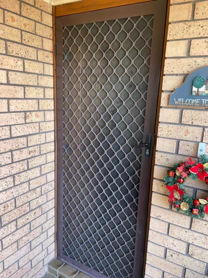 A Brick Wall With A Door And A Sign That Says Welcome To — Central Coast Flyscreen Service In Woongarah, NSW