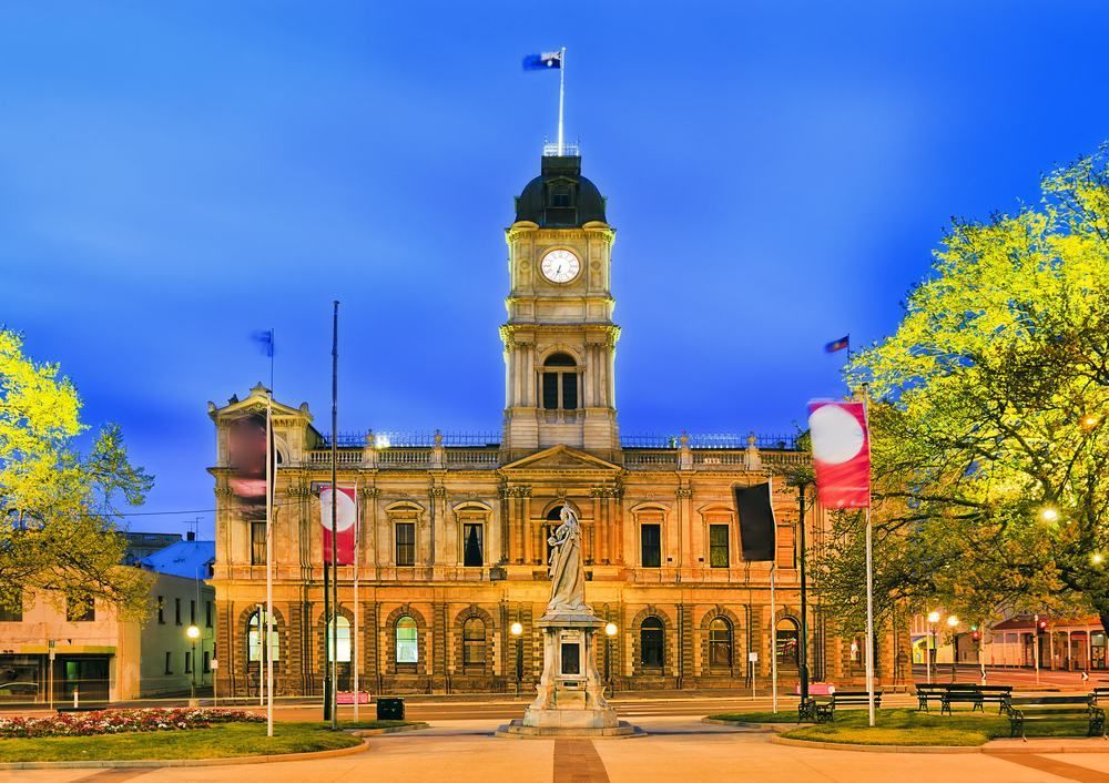 A Large Building With A Clock Tower And A Statue In Front Of It — Central Coast Flyscreen Service In Warnervale, NSW