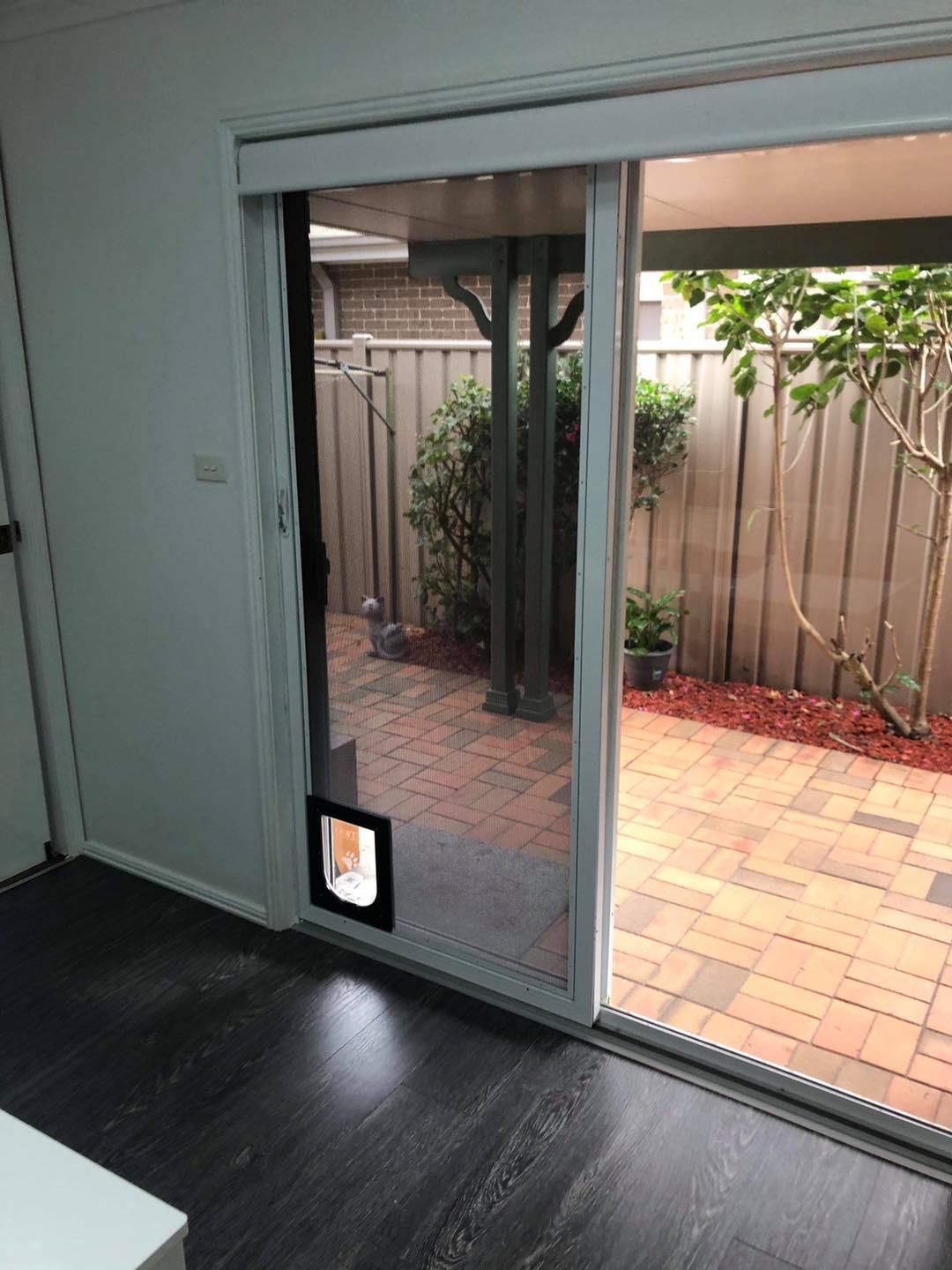 A Room With A Sliding Glass Door Leading To A Patio — Central Coast Flyscreen Service In Woy Woy, NSW