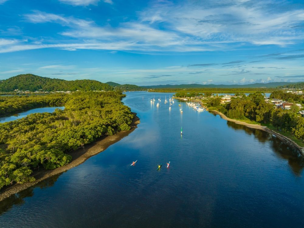 Waves Crashing On A Rocky Beach With A Lighthouse In The Background — Central Coast Flyscreen Service In Woy Woy, NSW