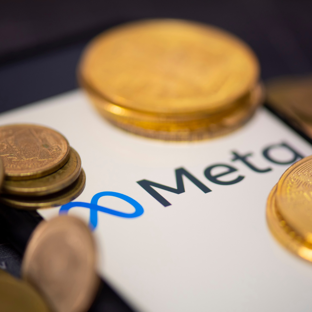 A bunch of gold coins on top of a white paper that says meta