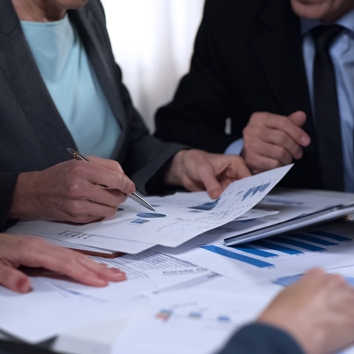 A man and a woman are sitting at a table looking at papers
